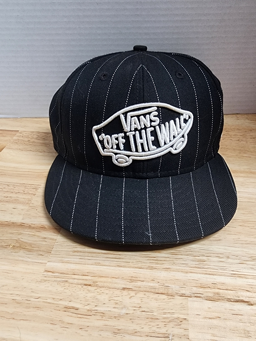 New Era Black Pinstripe Snapback Cap with White Embroidered Logo